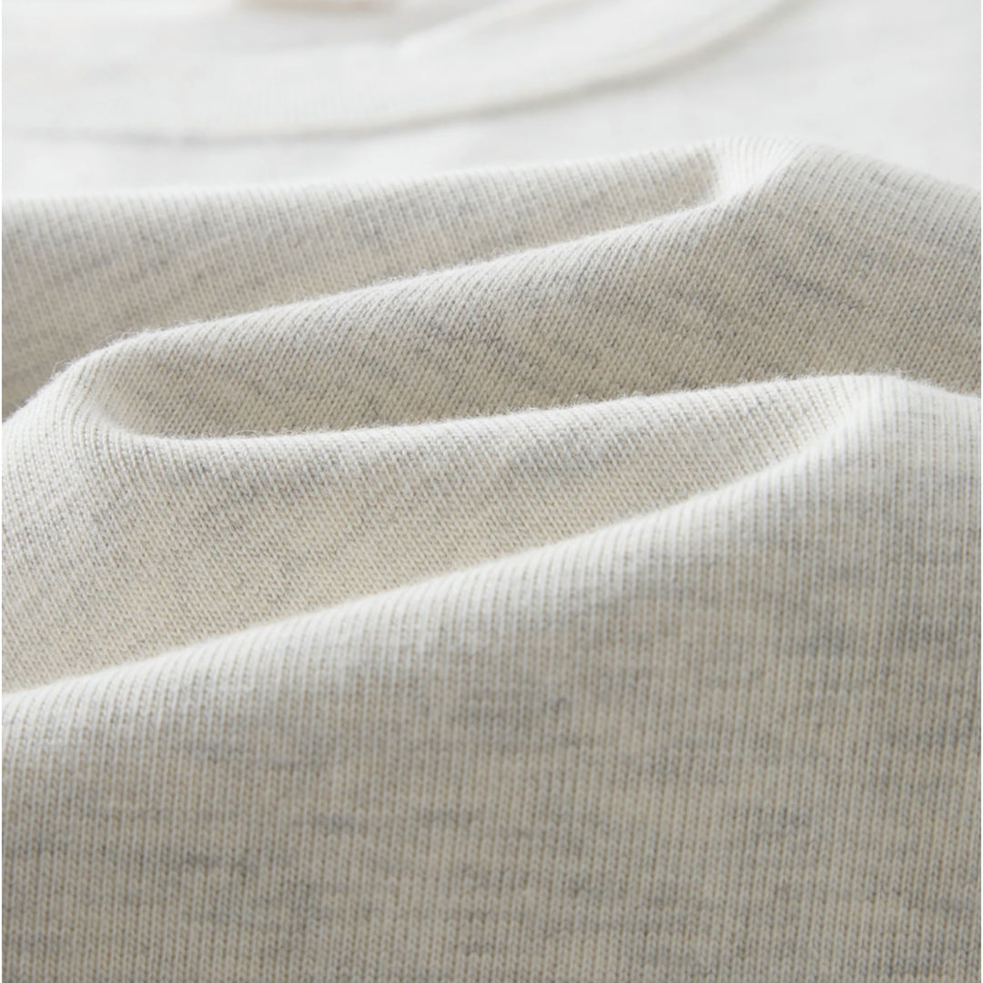 Macro close-up shot of Apostles Apparel Foundations Unisex Oversized Ultra Heavy Crew Neck in Heather Grey. Showcases the dense knit texture of the 425GSM ultra-heavyweight 100% cotton premium fabric, featuring 16S compact double yarn with a plush soft-touch finish and ribbed collar detailing.