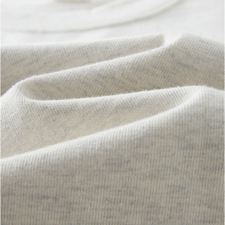 Macro close-up shot of Apostles Apparel Foundations Unisex Oversized Ultra Heavy Crew Neck in Heather Grey. Showcases the dense knit texture of the 425GSM ultra-heavyweight 100% cotton premium fabric, featuring 16S compact double yarn with a plush soft-touch finish and ribbed collar detailing.