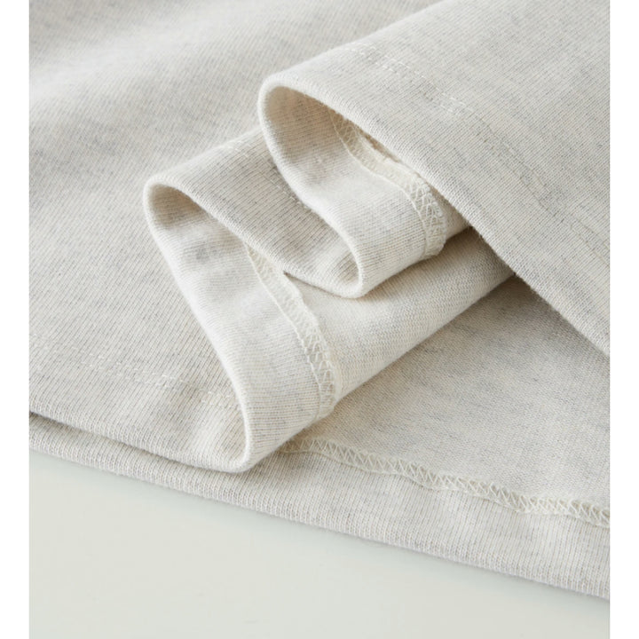 Macro detailing shot of Apostles Apparel Foundations Unisex Oversized Ultra Heavy Crew Neck in Heather Grey. Close-up highlights the premium construction, featuring deep coverstitch reinforcements on the cuffs and hem, heavy 425GSM cotton density, and robust side-seamed durability.