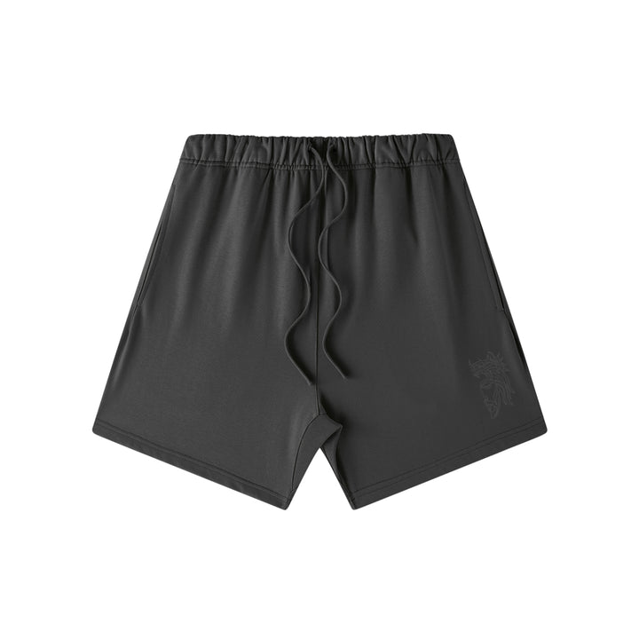 Front studio flat lay view of the Foundations Series Heavyweight Unisex Sweat Short in a black colorway. Features subtle high-density black Christ Half Face line-art embroidery on the left front leg panel, an overbuilt single-casing topstitched waistband with heavy-gauge tonal drawstrings, and a modern right-above-the-knee cut silhouette in massive 425GSM combed cotton French terry fabric.