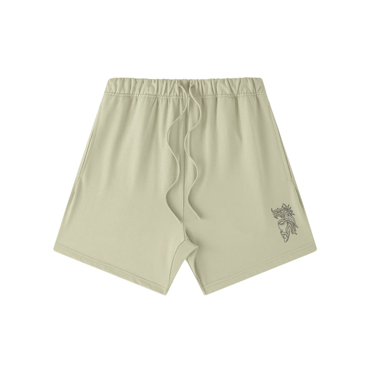 Front studio flat lay view of the Foundations Series Heavyweight Unisex Sweat Short in a pastel grey colorway. Features premium high-density Christ Half Face line-art embroidery on the left front leg panel, an overbuilt single-casing topstitched waistband with heavy-gauge tonal drawstrings, and a modern right-above-the-knee cut silhouette in massive 425GSM combed cotton French terry fabric.
