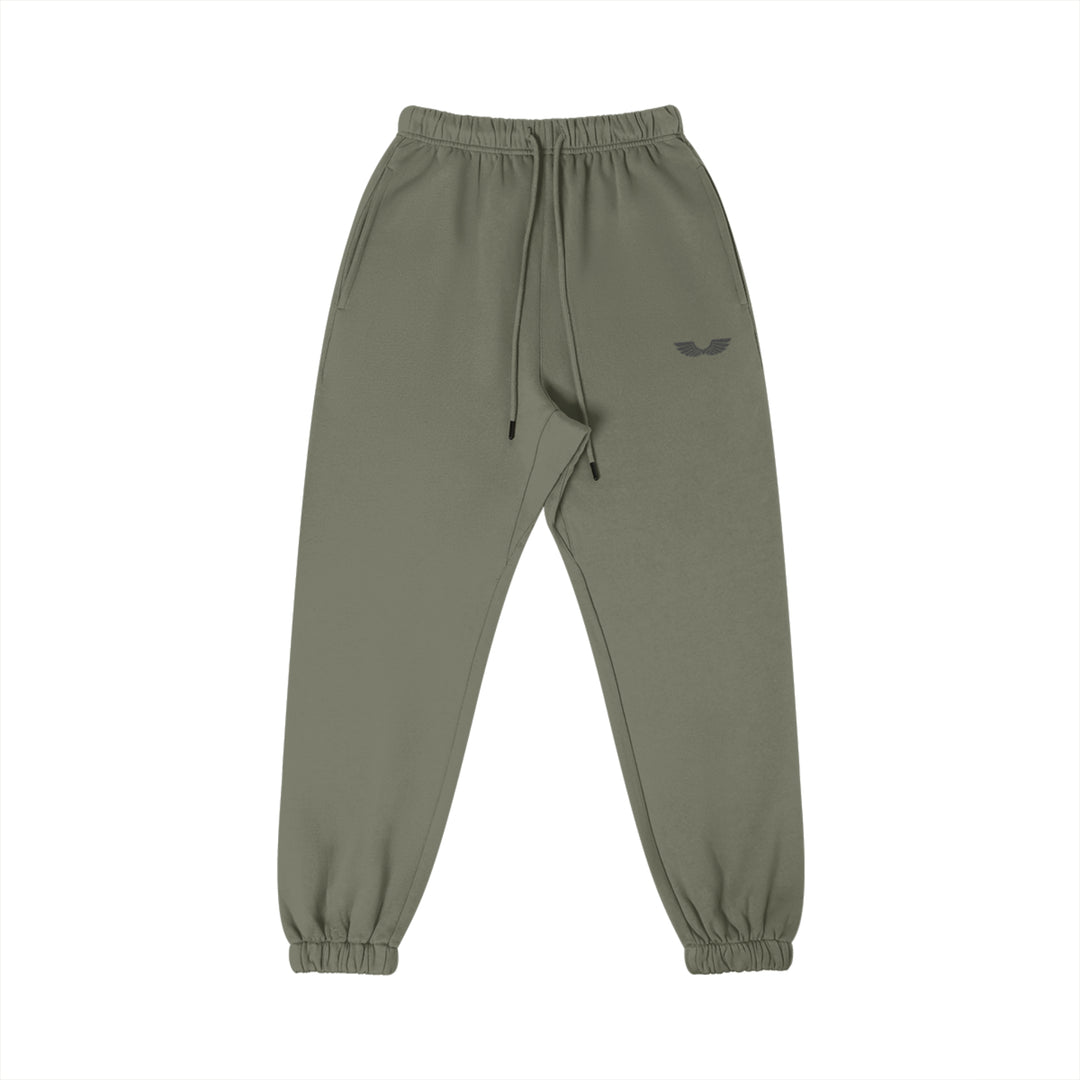 Front studio flat lay view of the Foundations Series Heavyweight Unisex Brushed Fleece Jogger in a charcoal grey tone, engineered as premium Christian streetwear. Features high-density Wings Emblem embroidery on the left thigh, a single-casing comfort waistband with heavy-gauge cotton drawstrings and black metal aglets, and elastic ankle cuffs built for a technical stacking silhouette. This structural 380GSM combed cotton piece represents mission-driven Christian clothing and pro-life Christian apparel.