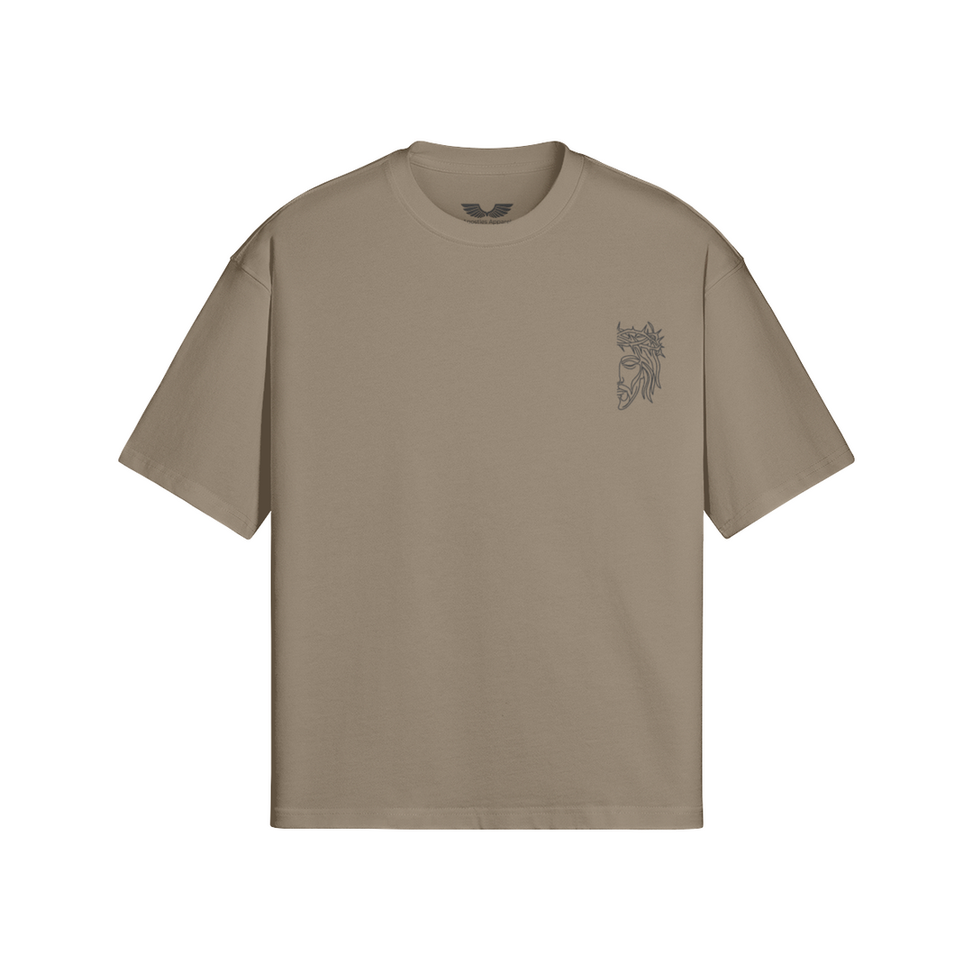 Front studio flat lay view of the Foundations Series Unisex Embroidered Boxy Tee in a deep Americano brown tone, designed as premium Christian streetwear. Features a relaxed, architectural boxy silhouette with dropped shoulders engineered from massive 280GSM heavyweight combed cotton, highlighted by the high-stitch count Christ Half Face line-art embroidery on the chest and a heavy-duty double-stitched ribbed collar for a mission-driven Christian clothing statement piece.