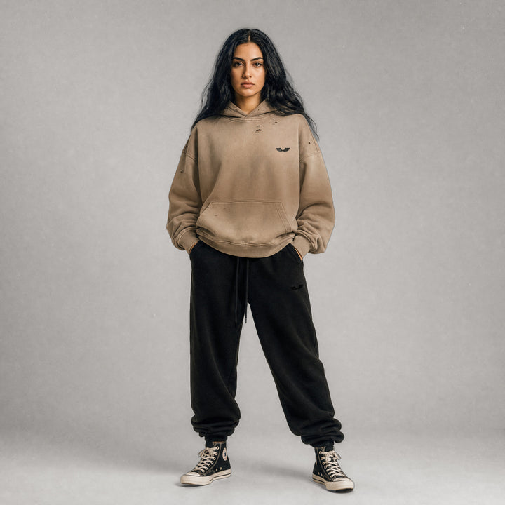 Full-body streetwear outfit layout featuring the Apostles Apparel Foundations Crown of Thorns Heavyweight Hoodie in faded and distressed camel paired with the brand&