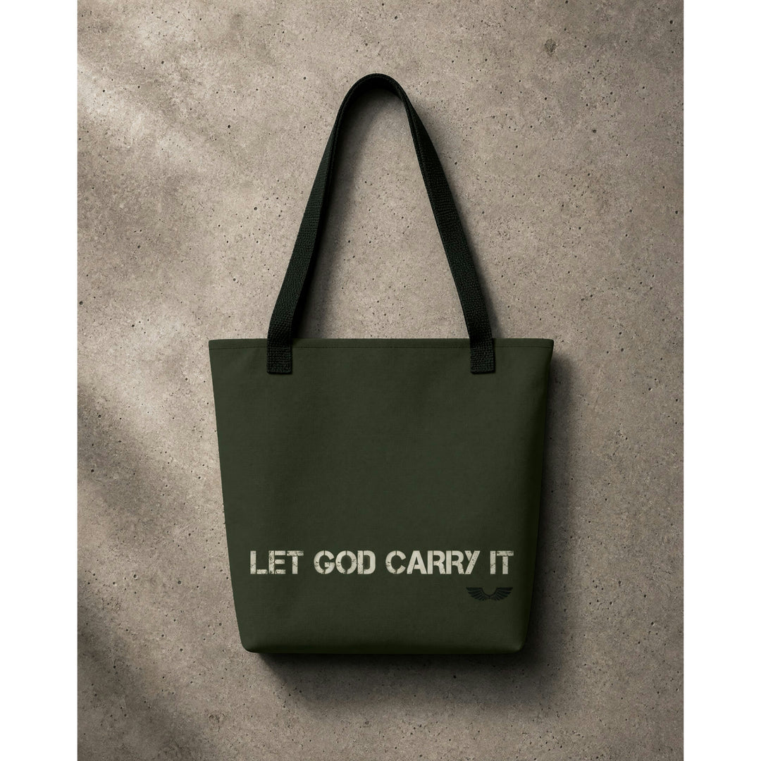 Front studio view of the Foundations Series Let God Carry It Utility Tote Bag by Apostles Apparel. Displays the high-density olive green polyester chassis, distressed white architectural typography across the body, a tonal wings logo, and rugged black cotton bull denim dual shoulder handles.